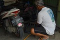 This is a tire repairman or workshop mechanic who is repairing the condition of motorcycle tires. Royalty Free Stock Photo