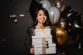 Blithesome latin model celebrating birthday. Indoor photo of gorgeous brunette girl with christmas presents