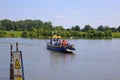 View on small passenger and bicycle ferry voet- en fietsveer on river maas in summer