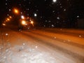 A truck with plow cleans the snow on the road