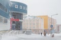 Blizzard in the city. Strong wind and blowing snow on the streets of a northern city in the Arctic.