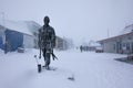 Longyearbyen, Norway - March 2019: Blizzard in Longyearbyen, statue of a coal miner in the snowfall. Svalbard, Norway