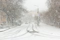 Blizzard, mist and snowfall in city, cars on sleet road, poor visibility, winter bad weather Royalty Free Stock Photo