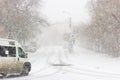 Blizzard, mist and snowfall in city, cars on sleet road, poor visibility, winter bad weather Royalty Free Stock Photo