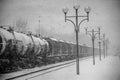 Blizzard on railway, freight train in snow