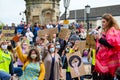 BLM protesters kneel and hold signs while wearing PPE Face Masks at a Black Lives Matter protest in Richmond, North Yorkshire Royalty Free Stock Photo
