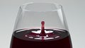 Blob splashing inside wine glass closeup. Drop falling inebriant beverage