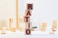 Block of alphabet letters forming the word RATIO on wooden surface. Concept of common marketing business terms