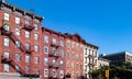 Block of apartment buildings in the Greenwich Village neighborhood of New York City with blue sky background Royalty Free Stock Photo