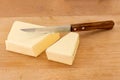 Block of butter cut with wooden handled knife