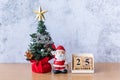 Block calendar date December 25 calendar and Christmas decoration - Santa Clause, tree and gift on wooden table. Christmas and Royalty Free Stock Photo