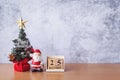 Block calendar date December 25 calendar and Christmas decoration - Santa Clause, tree and gift on wooden table. Christmas and Royalty Free Stock Photo