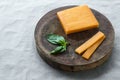 Block cheddar cheese, slices and basil leaves