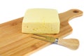 Block of cheese on cutting board with a knife, isolated on white background Royalty Free Stock Photo