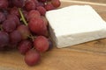 Block of feta cheese with fresh grapes Royalty Free Stock Photo