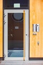 Block of flats facade with a glass door and an intercom