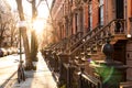 Block of historic brownstone buildings on Charles Street in the West Village neighborhood of New York City with afternoon sunlight
