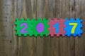 Block letters and numbers 2017 with wood background Royalty Free Stock Photo