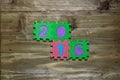 Block letters and numbers 2016 with wood background Royalty Free Stock Photo