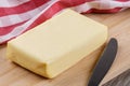 Block of Organtic butter islated on a wooden chopping board Royalty Free Stock Photo