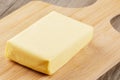 Block of Organtic butter islated on a wooden chopping board Royalty Free Stock Photo