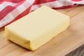 Block of Organtic butter islated on a wooden chopping board Royalty Free Stock Photo