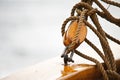 Block and ropes connecting to a railing on an old fishing vessel Royalty Free Stock Photo