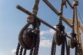 Block and tackle rigging on an old tall ship before blue sky, spliced and wrapped rope lines Royalty Free Stock Photo