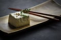 block of tofu in close-up view on wooden plate and chopsticks Royalty Free Stock Photo
