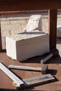 block of travertine marble with antique quarrying tools used to shape the stone Royalty Free Stock Photo