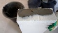 Block wall construction. A builder applies an adhesive mortar that uses lightweight concrete for construction. Applying Royalty Free Stock Photo
