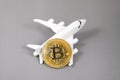 Blockchain airline ticket concept. Bitcoin Gold coin, plane on grey background. electronic virtual money.