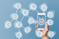 Blockchain and bitcoin technology and mobile computing concept on blue background