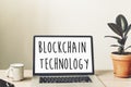 Blockchain technology text on laptop screen on wooden desktop wi Royalty Free Stock Photo