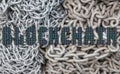 Blockchain text with oled screen macro pattern and chain background Royalty Free Stock Photo
