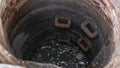 Blocked sewer drain. The water of recycling. Uninstalling septic tank with old iron manhole