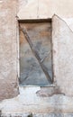 Blocked window on grunge weathered wall. Royalty Free Stock Photo