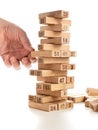 Blocks of game jenga on white background. Vertical tower whole and in game. Wooden blocks in stack with figures digit on