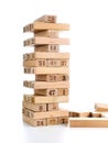 Blocks of game jenga on white background. Vertical tower whole and in game. Wooden blocks in stack with figures digit on