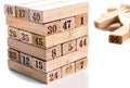 Blocks of game jenga on white background. Vertical tower whole and in game. Wooden blocks in stack with figures digit on