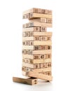 Blocks of game jenga on white background. Vertical tower whole and in game. Wooden blocks in stack with figures digit on Royalty Free Stock Photo