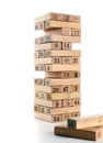 Blocks of game jenga on white background. Vertical tower whole and in game. Wooden blocks in stack with figures digit on Royalty Free Stock Photo