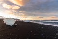 Black sand beach dotted with blocks of ice at sunset in summer Royalty Free Stock Photo
