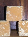 Blocks of Indian jaggery on Wooden background