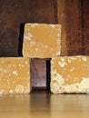 Blocks of Indian jaggery on Wooden background