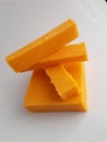 Blocks of orange cheddar cheese isolated on a white background Royalty Free Stock Photo