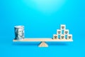 Blocks with symbols of business shops and a bundle of money dollars on scales. Franchising. Assessing value of a business empire. Royalty Free Stock Photo