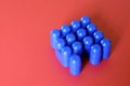 Buildable colored plastic blocks to play, build and organize on a red background as a concept of inclusion, diversity and pluralit Royalty Free Stock Photo