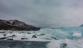 Blocks of turquoise ice floes lie on the frozen lake. Royalty Free Stock Photo