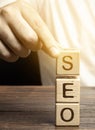 Blocks with the word SEO and businessman. Search Engine Optimization. Increase the quality and quantity of website traffic by Royalty Free Stock Photo